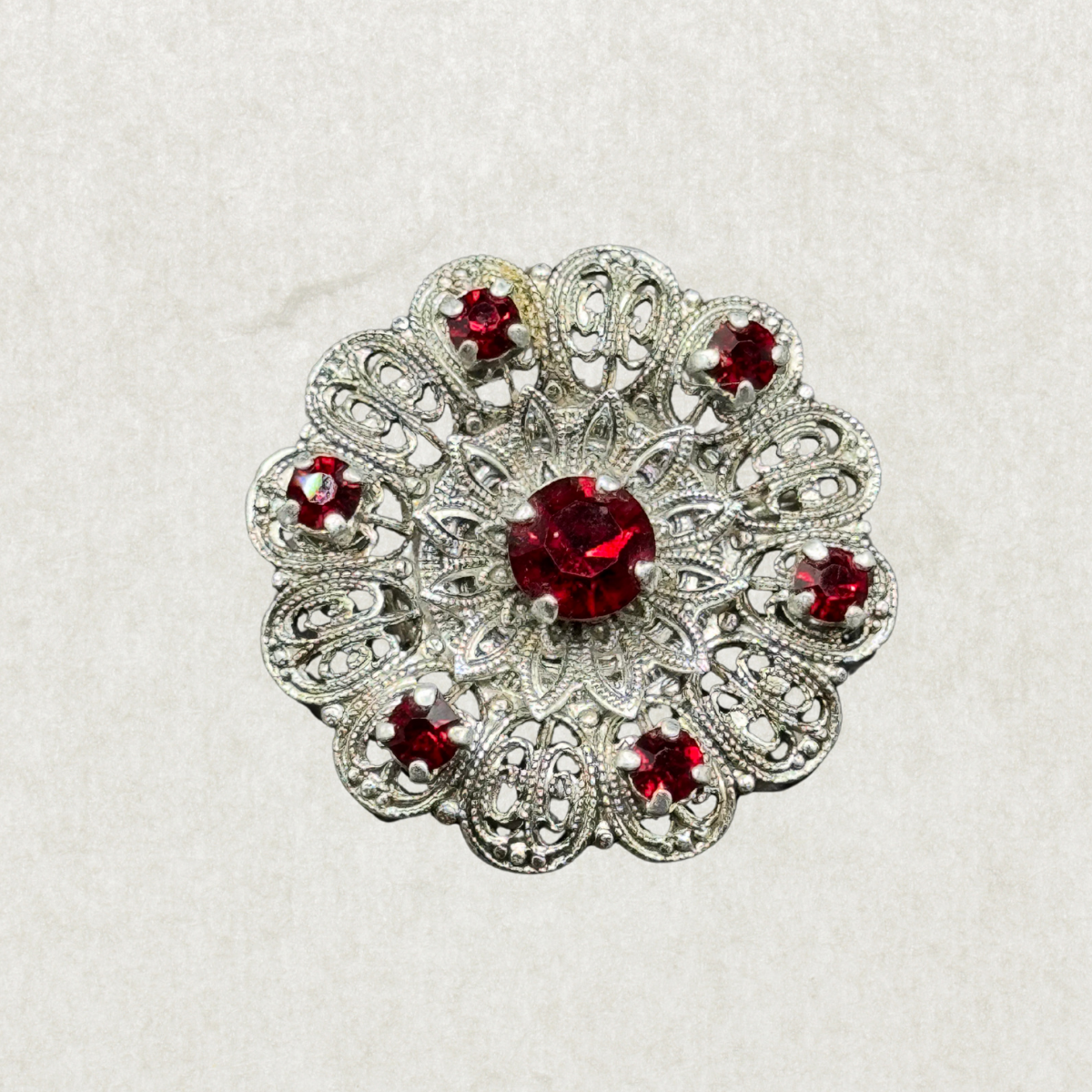 Vintage Silver-Tone Filigree Brooch with Red Stones